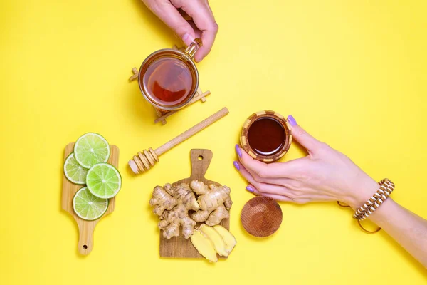 Lime, ginger, Honey Cup of Herbal Tea. Flat Lay, CopySpace. Alternative cold and flu remedy. Healthy Food. on yellow background