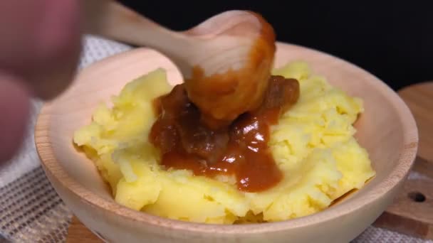 Hungarian goulash on a rustic background with mashed potatoes. selective focus — Stock Footage Hungarian goulash on a rustic background with mashed potatoes. selective focus Stock Footage