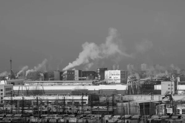 Smoke comes from industrial red-white pipes. Industrial zone environmental pollution selective focus