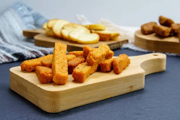 brown toast crackers croutons on a wooden board space for copying text, no waste