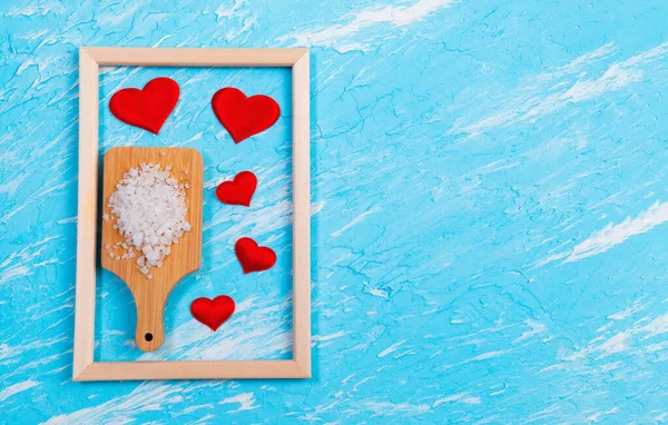 sea salt for food love heart on blue background with space to copy text