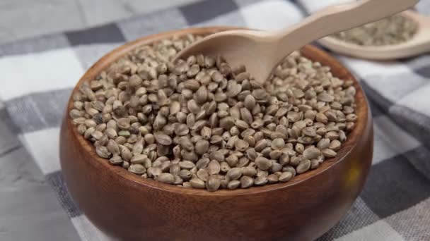 Cannabis seeds with a heart. ground Organic Hemp seed. texture. Hemp seeds background — Stock Video