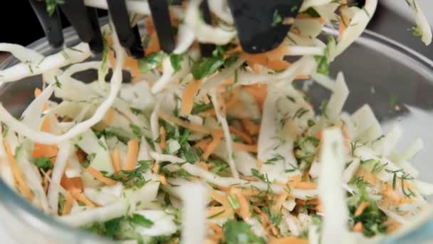 Preparation of a salad of cabbage, cucumber and carrot. vegetarian food, slow motion — Stock Video