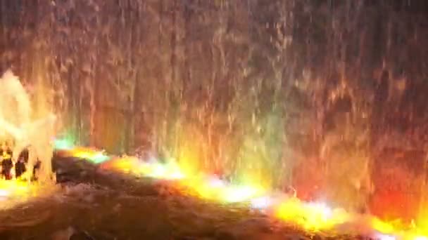 Luci sfocate versando anche cascata di luci d'acqua multicolore illuminate. fontana notturna — Video Stock