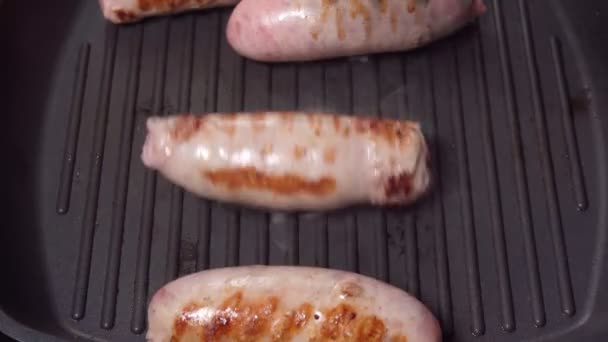 Cooking sausages close-up on a grill pan. Cooking food — Stock Video