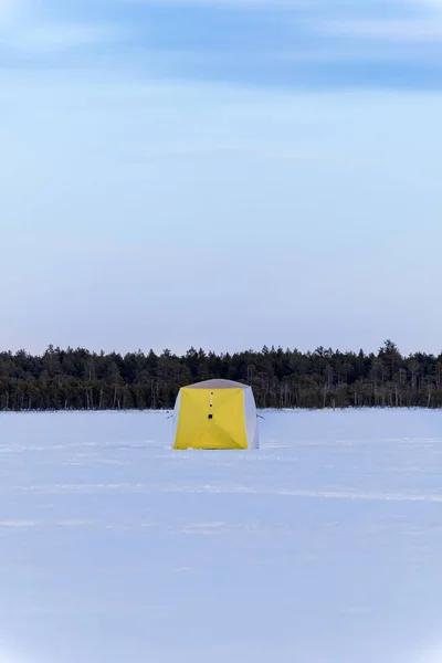 winter tent on the lake for fishing. winter sports vertical photo