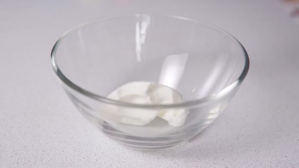 A nata azeda vaza-se com uma colher em um boliche transparente. Cozinhar alimentos — Vídeo de Stock