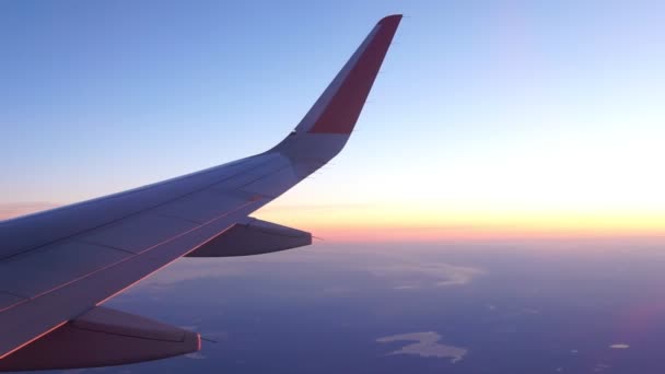 飛行機は日没の劇的な光の中で雲の上を飛んでいます。高速移動の概念 — ストック動画