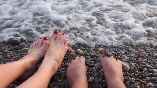 Pies de turistas descansando en el mar. Una chica y un chico. enfoque selectivo — Vídeos de Stock
