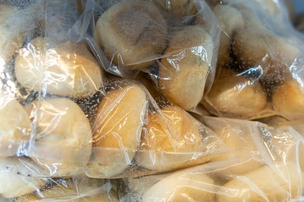 frozen burger buns. Transparent plastic bags in the refrigerator in the kitchen of the restaurant or cafe.