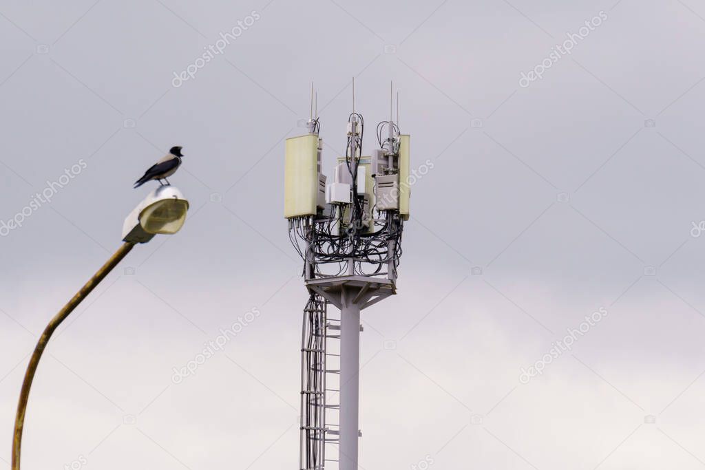 Telecommunication towers. A 4 G or 5 G wireless communication transceiver. Selective focus