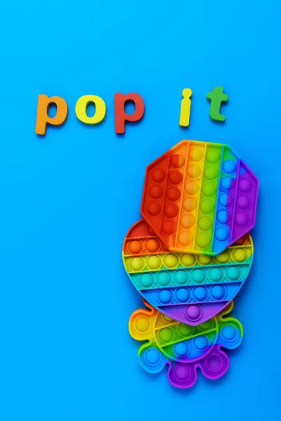 Toy pop it. Poppit is a new fidget toy, popular among children and people with special needs. On a blue background