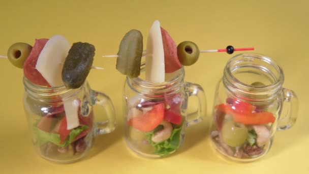 Glass jar jarcuterie nuts, olives, cheese, meat chips, salad. Healthy good carbs and fats, a light snack. — Stock Video