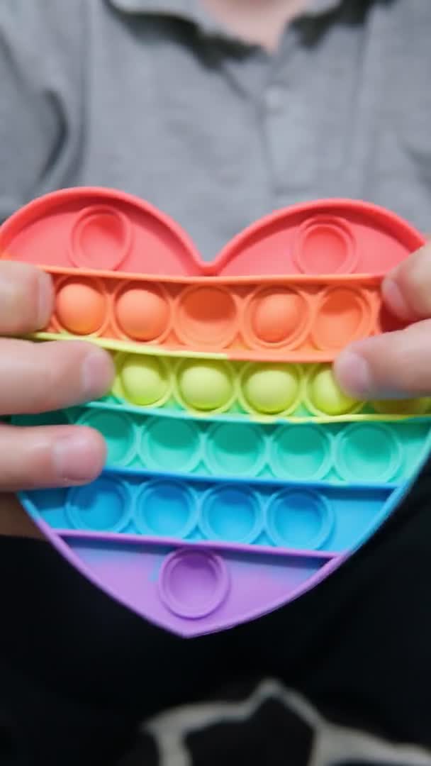 Rainbow anti stress toy fidget. Silicone toy antistress pop it. Close up. Vertical video — 图库视频影像