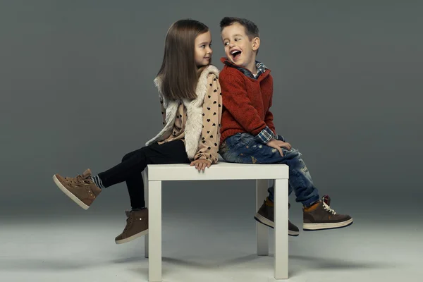 A portrait of a laughing girl and a smiling boy. Autumn style — Stock Photo, Image