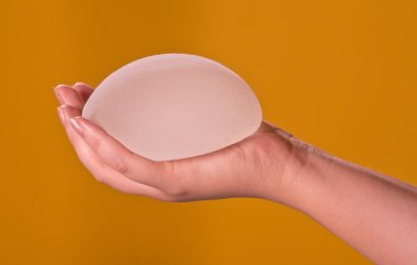 Silicone implants on hand clipart