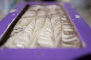 Evde erkeklerin elleriyle yaptığı el yapımı tarçın sabunu. Diy. Mor silikon kalıbını doldurdum. Dalgalı bir topoğrafyası var. İki farklı renkten oluşur..