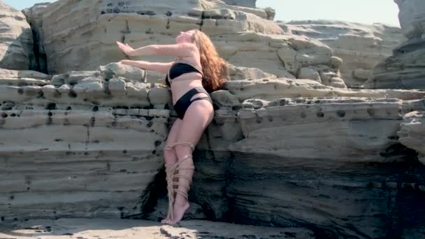 Uma Menina Amarrada Com Cordas Flutua Água Fica Sobre Pedras — Vídeo de Stock