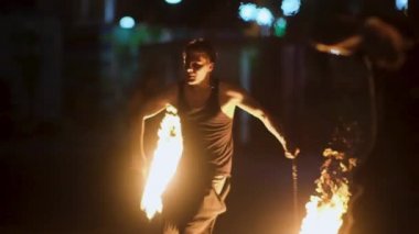 Vladivostok, Rusya - 29 Ağustos 2021: sokak oyuncuları yangın şovu, erkekler gece geç saatlerde izleyicilerin önünde yangın enstrümanlarıyla dans ediyor