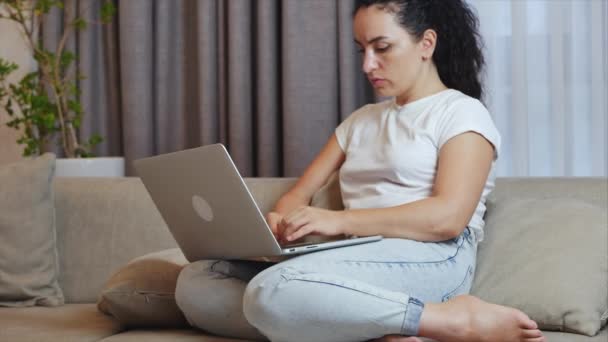 Freelancer lavoro giovane donna è responsabile compito importante sulla posta elettronica freelance a casa digitando sul computer portatile, ocused fa il trasferimento di denaro online, utilizzando un computer per il pagamento online a casa, seduto sul letto — Video Stock