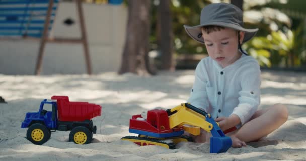 Дети играют с пластиковой машиной в песке на пляже. Крупный план детских рук, играющих с песком на пляже, пластиковые игрушки. — стоковое видео