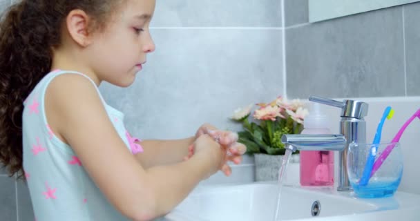 Portrait happy cute young child brushing teeth in bathroom and smiling. Children daily healthcare routine. Caucasian kid with white tooth looking at mirror isolated at home. Lifestyle. — Stock Video