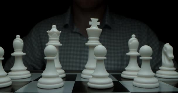 White moves with a pawn. Super-macro photography of a chessboard with chess, camera travel on a slider from white pieces to black ones.Game of chess. Filmed in a dark key. — Video Stock