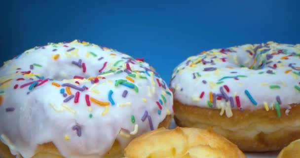 Super macro close-up shot of delicious sweet donuts with colorful frosting and donuts with cream inside. — Stock Video