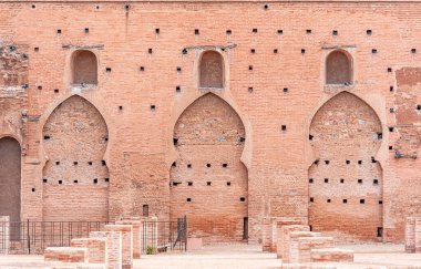 Ancient walls of medina in Marrakech, part of Kutubiyya mosque, arabian style of doors and windows, buildings by red clay, Morocco clipart