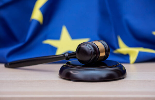  Flag of European Union and judges wooden gavel on the top, concept picture about court and justice