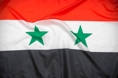 Arka plan olarak Suriye 'nin kumaş ulusal bayrağı