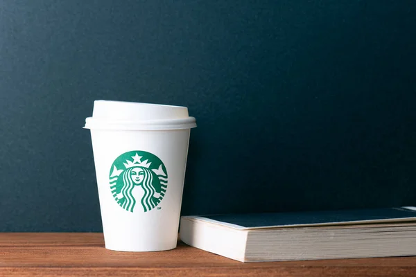 Berlin Mai Papierweißer Becher Mit Starbucks Logo Und Buch Auf — Stockfoto