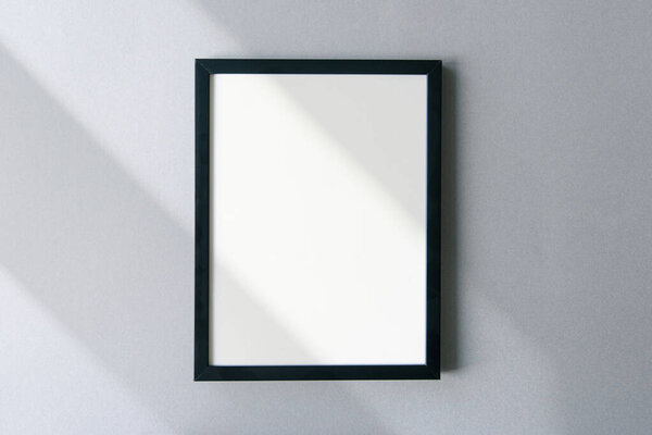 Blank photo frame mockup with shadows and sunlight on surface. Template with space for text.