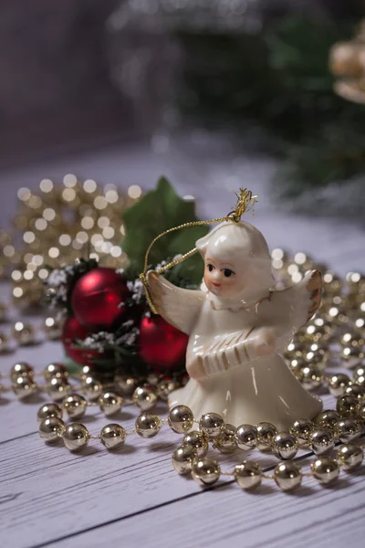 Weihnachtsengel steht auf dem Holztisch mit Weihnachtskette — Stockfoto