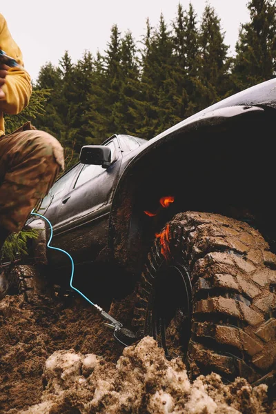 Putting the tire on the dist with gas and fire. Offroad trick. Wheel boarding in the mountains.