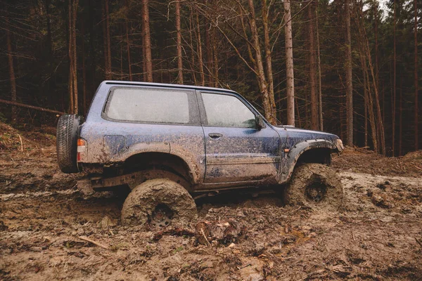 Dirty cars and wheels in the mountains. Swamp on the tires. Trips offroad across Ukraine. View of the Carpathian Mountains.