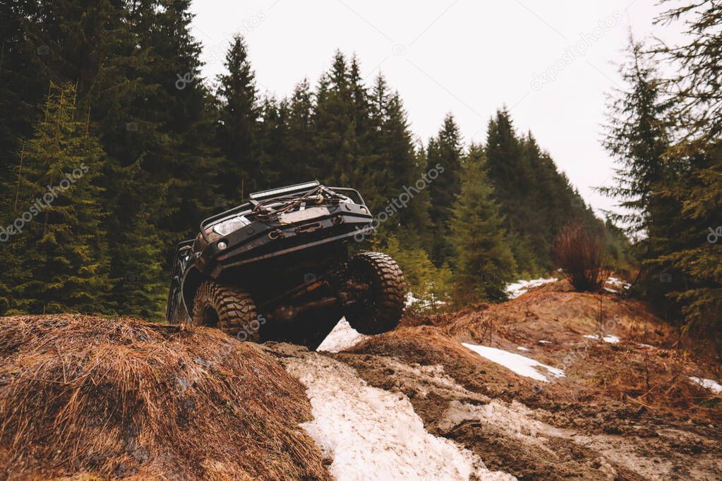 Offroad car jump in the mountains. Pollen, swamp and snow. Affortation, suspension, tires