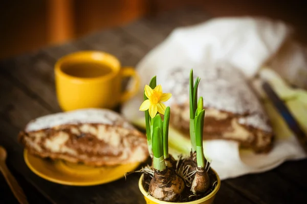 Påskliljor blommor och tårta. Stockfoto