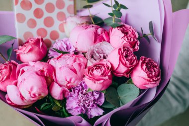 Bright bouquet of pink peonies, roses and carnations of different shades. Summer background