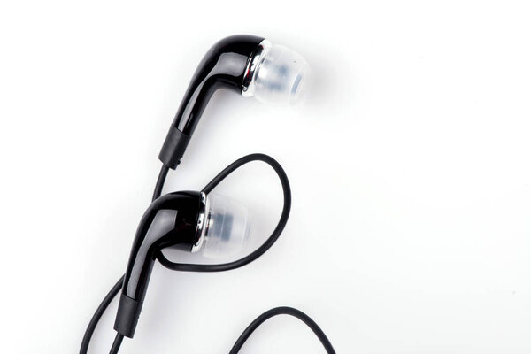 Black wired headphones on a white background. vacuum headphones