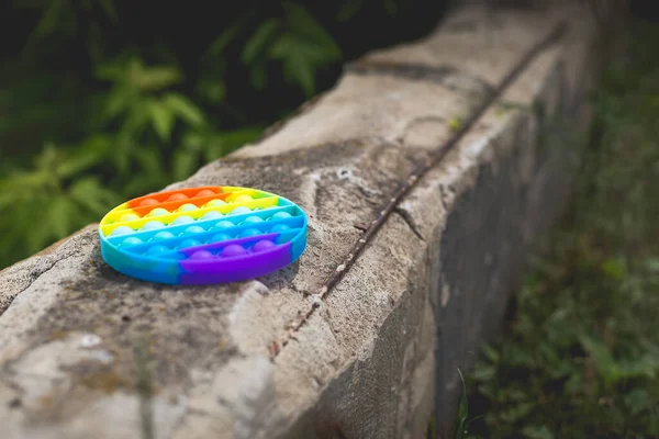 Antistress Toy Pop Rainbow Colors Lies Gray Concrete Floor — Stock Photo, Image