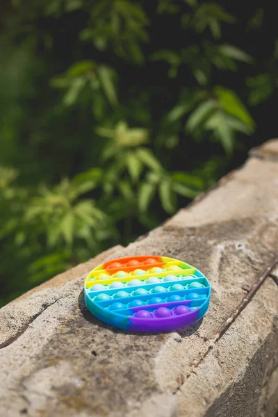 Antistress Toy Pop Rainbow Colors Lies Gray Concrete Floor — Stock Photo, Image