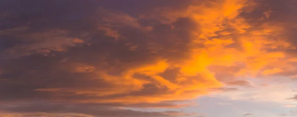 The morning sky looked like a bright golden sky. The sunrise is decorated with clouds in various shapes. Looks beautiful.