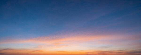 The morning sky looked like a bright golden sky. The sunrise is decorated with clouds in various shapes. Looks beautiful.