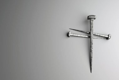 Beyaz arka planda çapraz şekil oluşturan üç çivi.