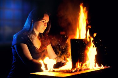 Woman uses a burning laptop clipart