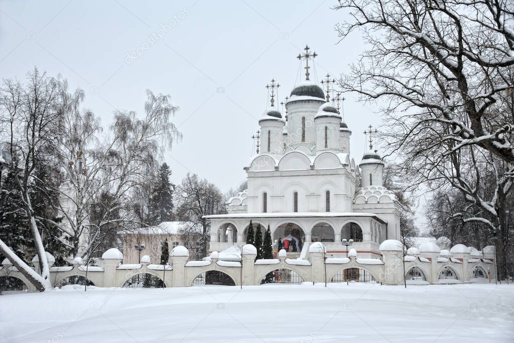 MOSCOW REGION, RUSSIA - Old Transfiguration church in Bolshie Vyazemy framed by trees during snowfall in Christmas time