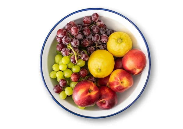 White enamel bowl with blue rim filled with fresh fruits — Stock Photo, Image