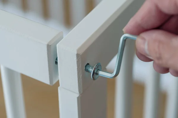 Person assembling furniture using a hex wrench — Stok fotoğraf