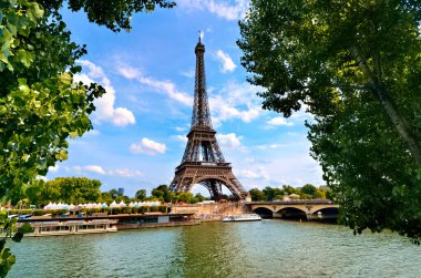Eyfel Kulesi, Paris sembolik simgesi Seine nehri boyunca yeşil yapraklı, mavi gökyüzü, Fransa